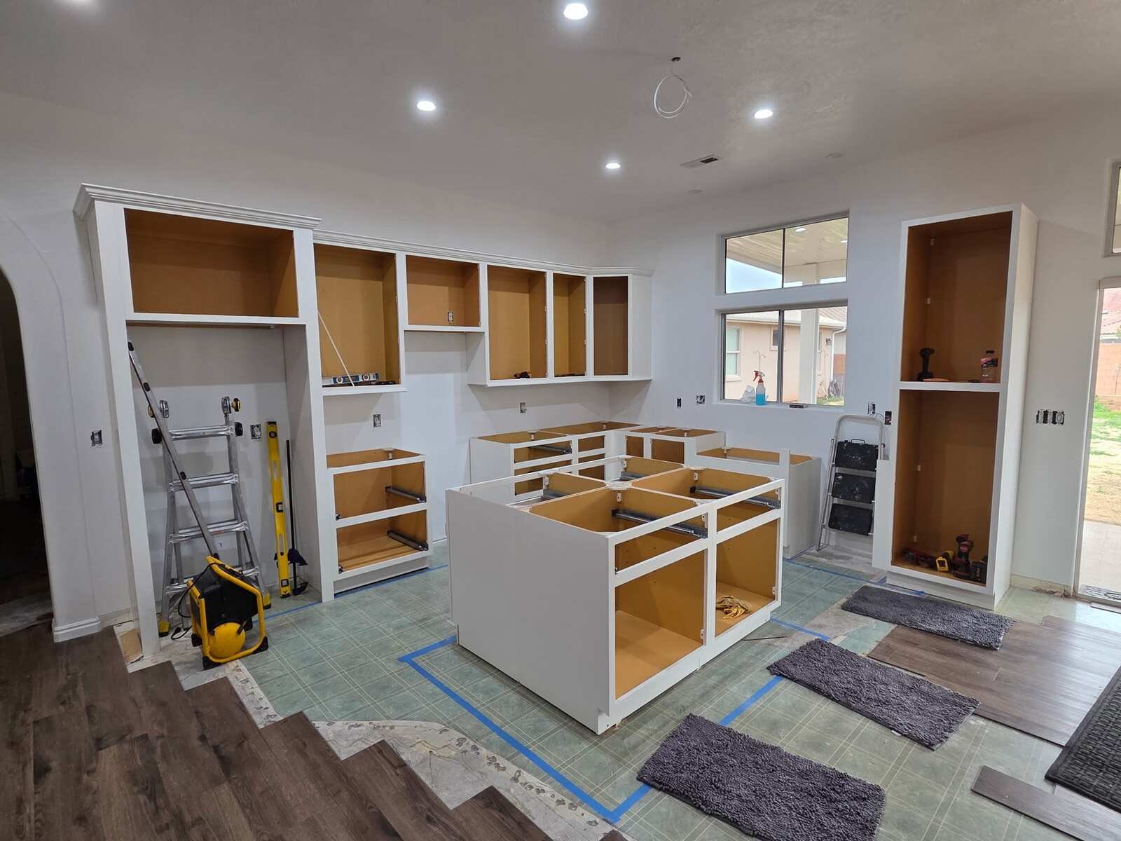 New white cabinets and island going into a kitchen remodel by Y-Not Handyman & Remodel in Washington County